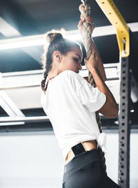 Low angle view of woman standing against the wall