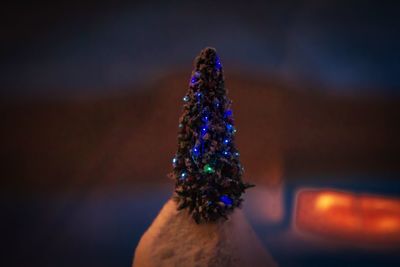 Close-up of hand holding illuminated christmas lights