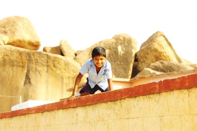 Portrait of a young woman sitting on bench