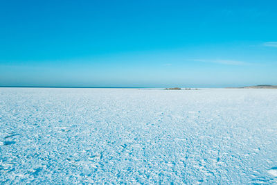 Scenic view of sea against blue sky