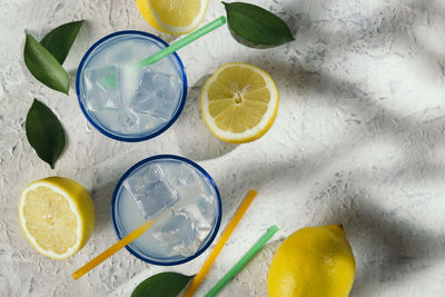 Lemon juice glasses under the shade of a tree at an outdoor picnic