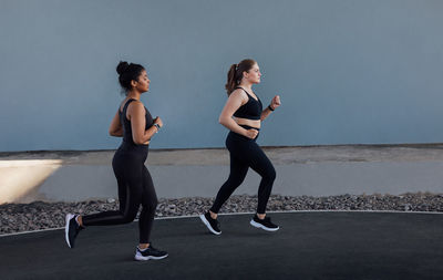 Side view of woman exercising on road