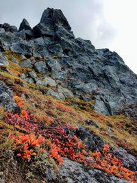 Low angle view of rocks on mountain against sky