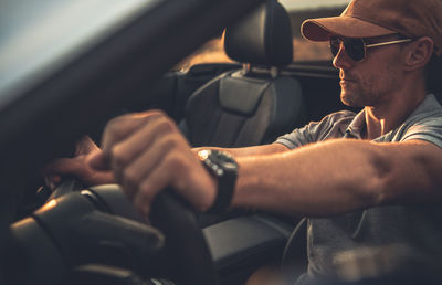 Midsection of man sitting in car