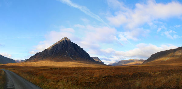 Scenic view of mountain range against blue sky