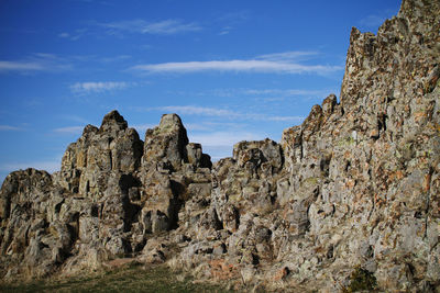 Low angle view of rock formations against sky