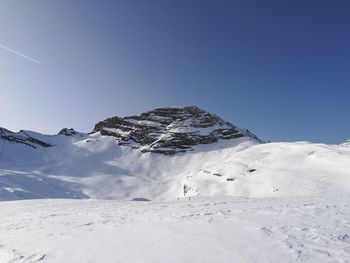 Scenic view of snowcapped mountain against clear blue sky