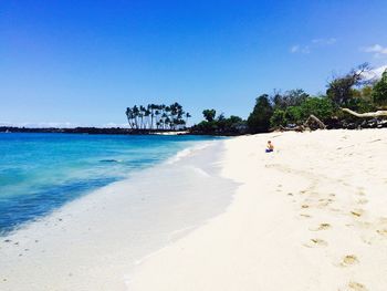 Scenic view of beach against blue sky