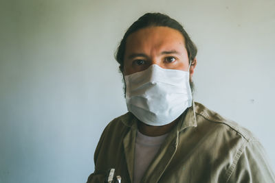 Portrait of mid adult man against white background