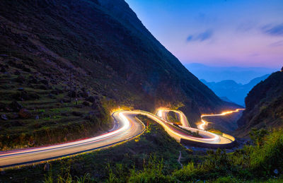 High angle view of road by mountains against sky