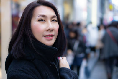 Portrait of smiling woman in city