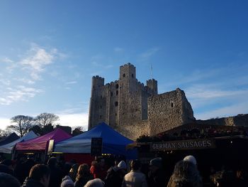 People at town square against sky