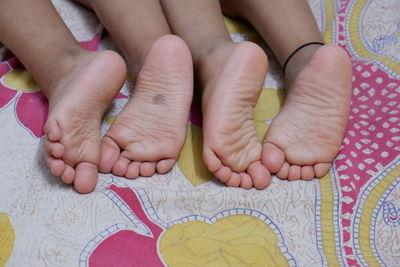 Low section of baby feet on bed