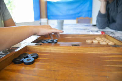 Midsection of people playing leisure game 