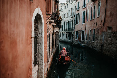 Man in boat against canal