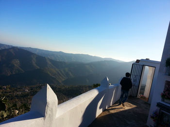 Tourists at observation point against clear sky