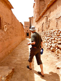 Full length side view of shirtless man