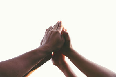 Close-up of hand touching against white background