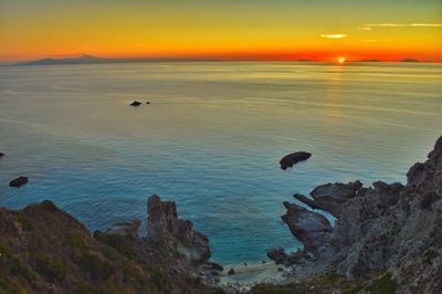Scenic view of sea against orange sky