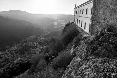 Scenic view of historic building by mountains against sky