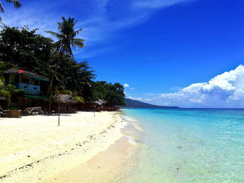 Scenic view of beach against blue sky