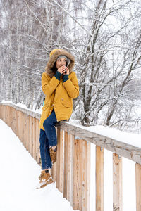 Full length of woman on snow covered field during winter