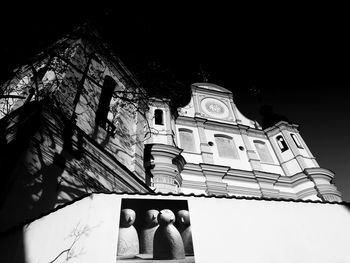 Low angle view of temple and building against sky at night