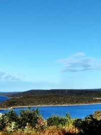 Scenic view of landscape against blue sky