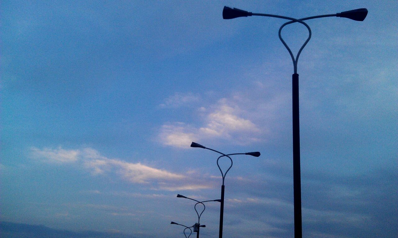 street light, low angle view, lighting equipment, sky, pole, lamp post, cloud - sky, silhouette, blue, electricity, electric light, nature, tree, cloud, no people, outdoors, dusk, cloudy, day, tranquility