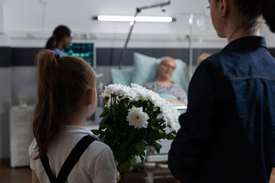 Rear view of woman holding bouquet