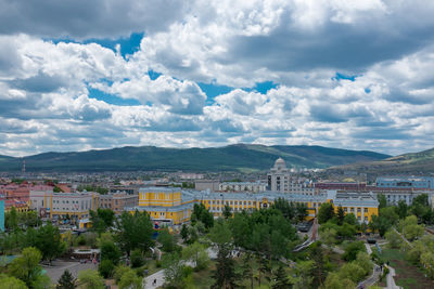 Town by mountains against sky