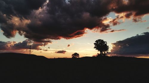 Silhouette landscape against dramatic sky