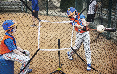 Boys playing baseball on field