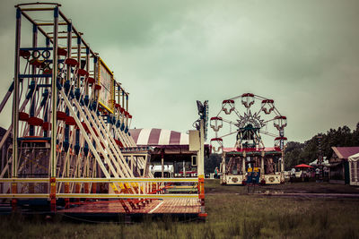 Amusement park rides against sky