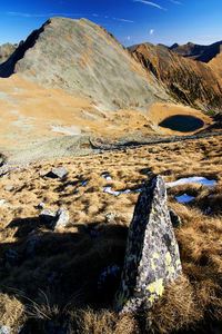 Scenic view of mountains against blue sky during sunny day