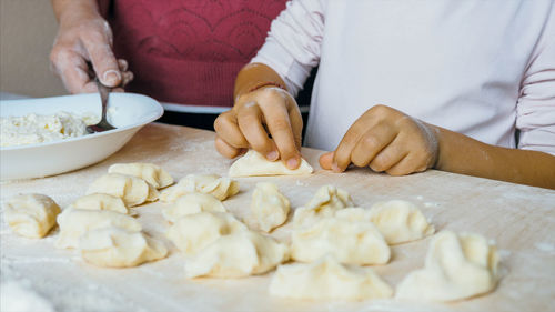 Midsection of woman preparing food on table