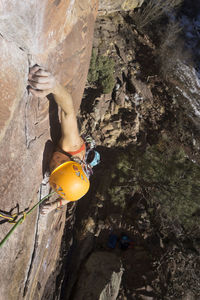 High angle view of confident female hiker climbing mountain