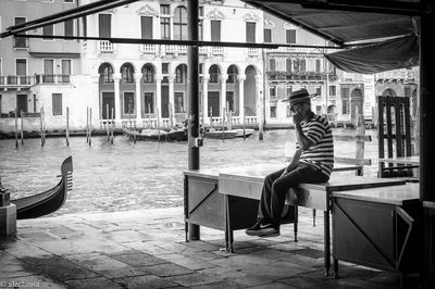 People sitting in front of building in city