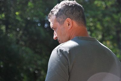 Portrait of man looking away in forest