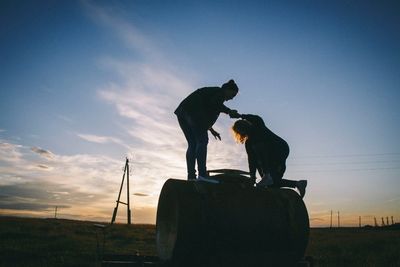 Female friends playing with a tank in a field