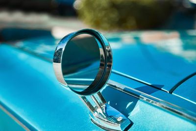 Close-up of mirror on car