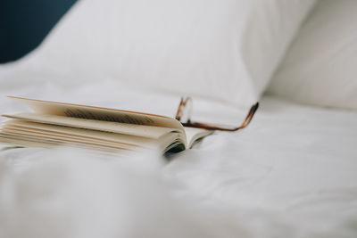 High angle view of open book on bed