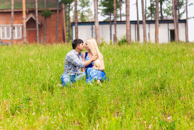 Full length of couple on field