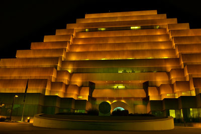 Low angle view of illuminated building at night