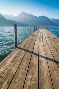 Wooden pier over sea against sky