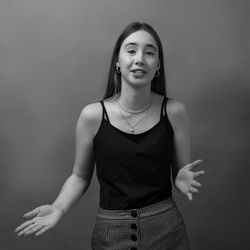 Portrait of beautiful woman standing against wall