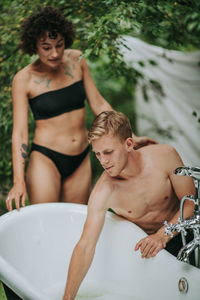 Portrait of young shirtless man in water