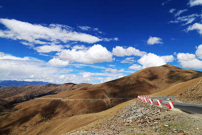 Scenic view of desert against cloudy sky