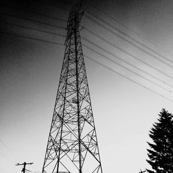 Low angle view of communications tower against sky