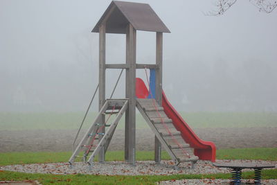 Slide at playground in foggy weather